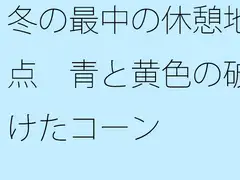 冬の最中の休憩地点 青と黄色の破けたコーン